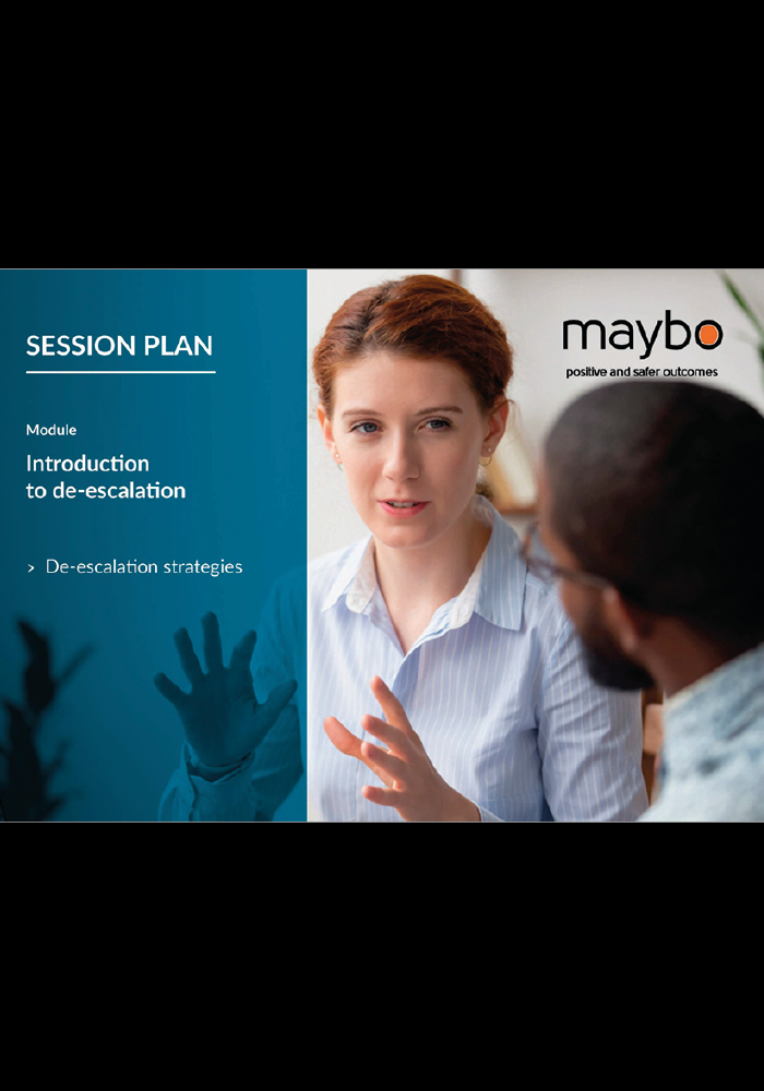 A woman engaged in a discussion about de-escalation strategies, with a focus on effective communication techniques.