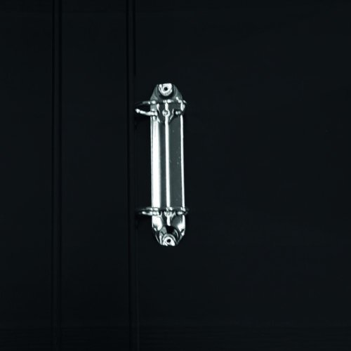 Close-up view of a binder clip attached to a black folder, showcasing its metallic fastener.