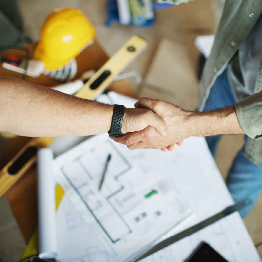 Builder shaking hands with client